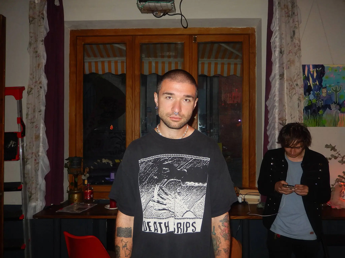 A portrait of the artist Cherim standing in a room while looking straight into the camera
